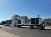 The massive vehicle charging units, weighing a whopping 12,000 lbs. each and standing 21 feet high, are located in the parking lot near Fresno and Harvard Streets.