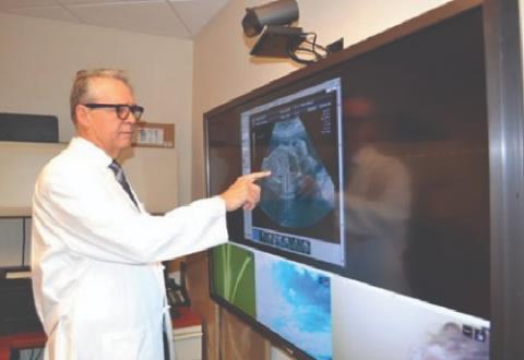 Dr. Curtis Lowery, associate chief of research and development at VA Pacific Islands Health Care System (VAPIHCS), taken as the Doctor was reviewing a fetal ultrasound. 